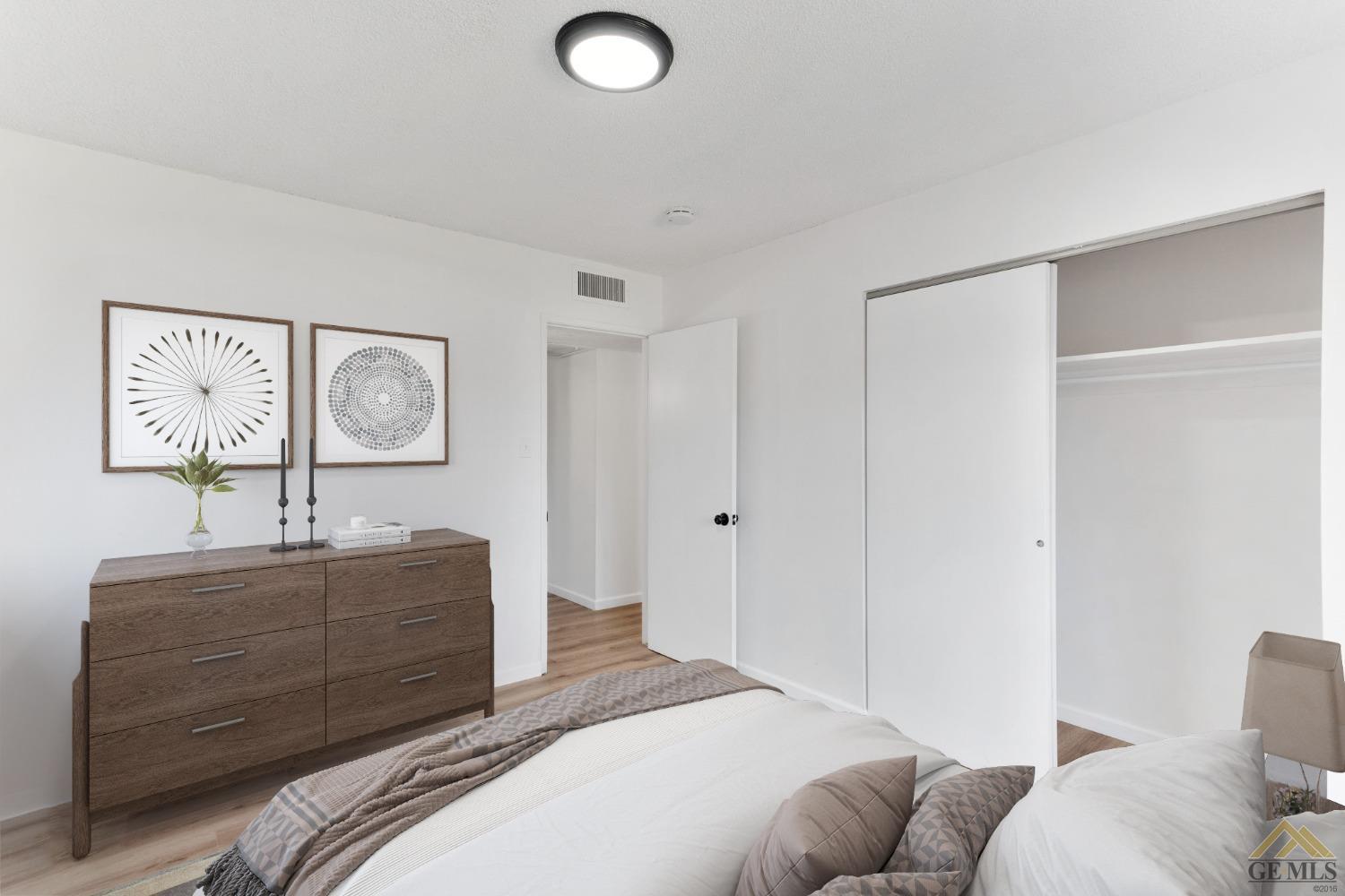 Undisclosed Address Bakersfield, CA 93308 - Photo 19 of 27 a bedroom with a bed and a dresser in it