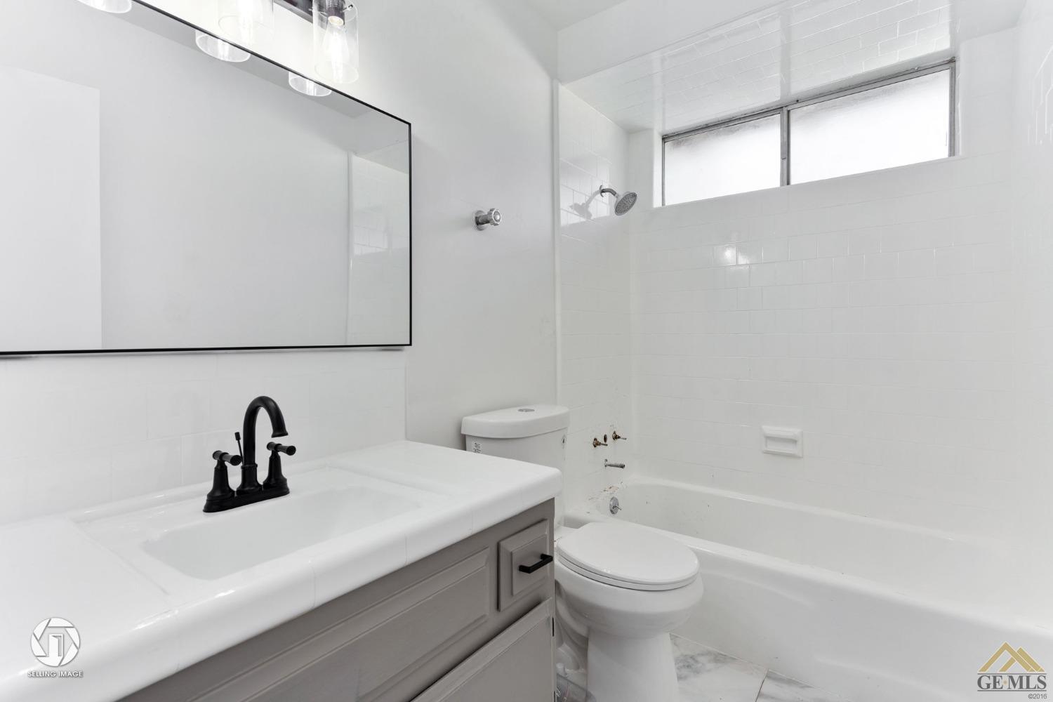 Undisclosed Address Bakersfield, CA 93308 - Photo 20 of 27 a bathroom with a sink a toilet and a bathtub