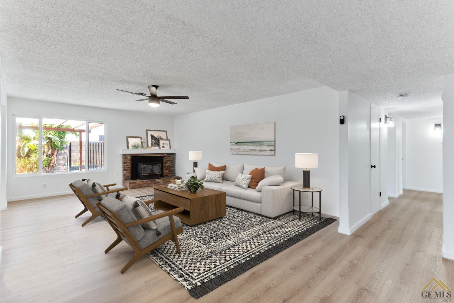 Undisclosed Address Bakersfield, CA 93308 - Photo 5 of 27 a living room with furniture and a fireplace