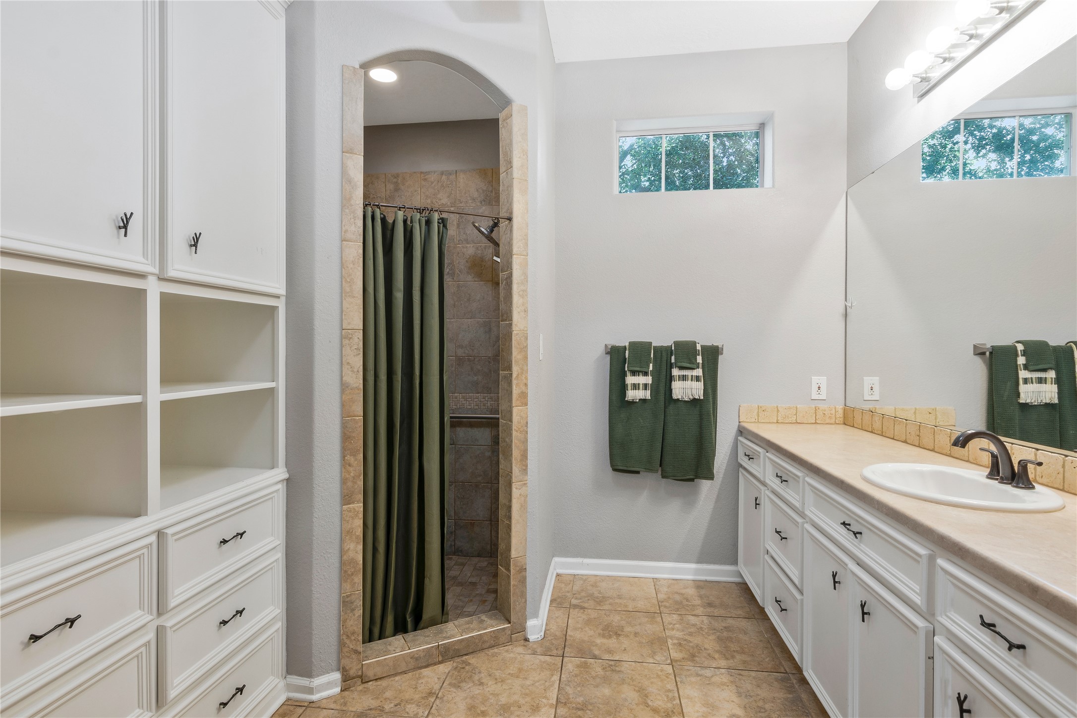 13914 Skinner Road Cypress, TX 77429 - Photo 31 of 50 Mother In Law Suite: Bright bathroom with a long vanity, built in storage, skylight, and walk in shower.