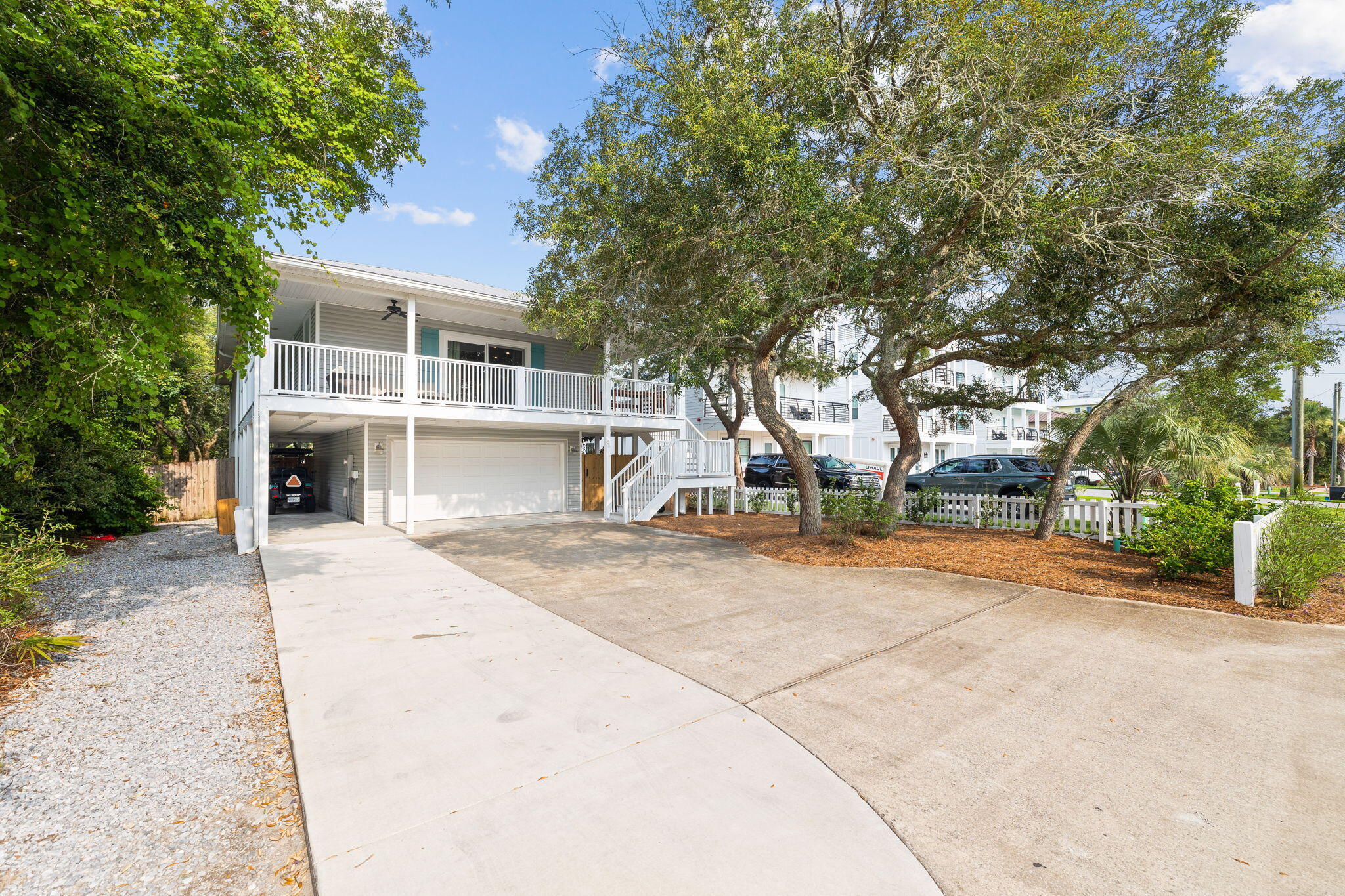 85 Dolphin Street Destin, FL 32541 - Photo 2 of 63 a front view of a house with a yard and garage