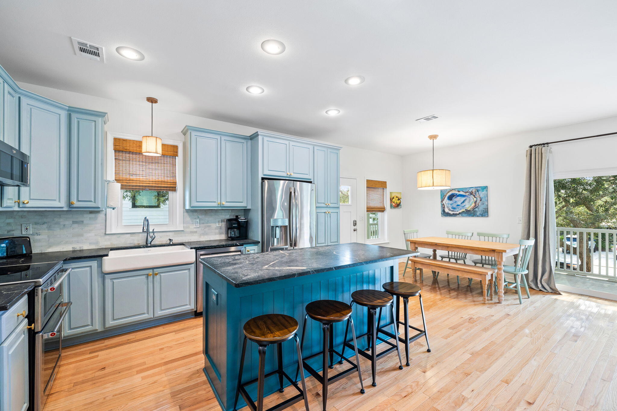 85 Dolphin Street Destin, FL 32541 - Photo 24 of 63 a kitchen with stainless steel appliances granite countertop a stove top oven a sink dishwasher and white cabinets with wooden floor