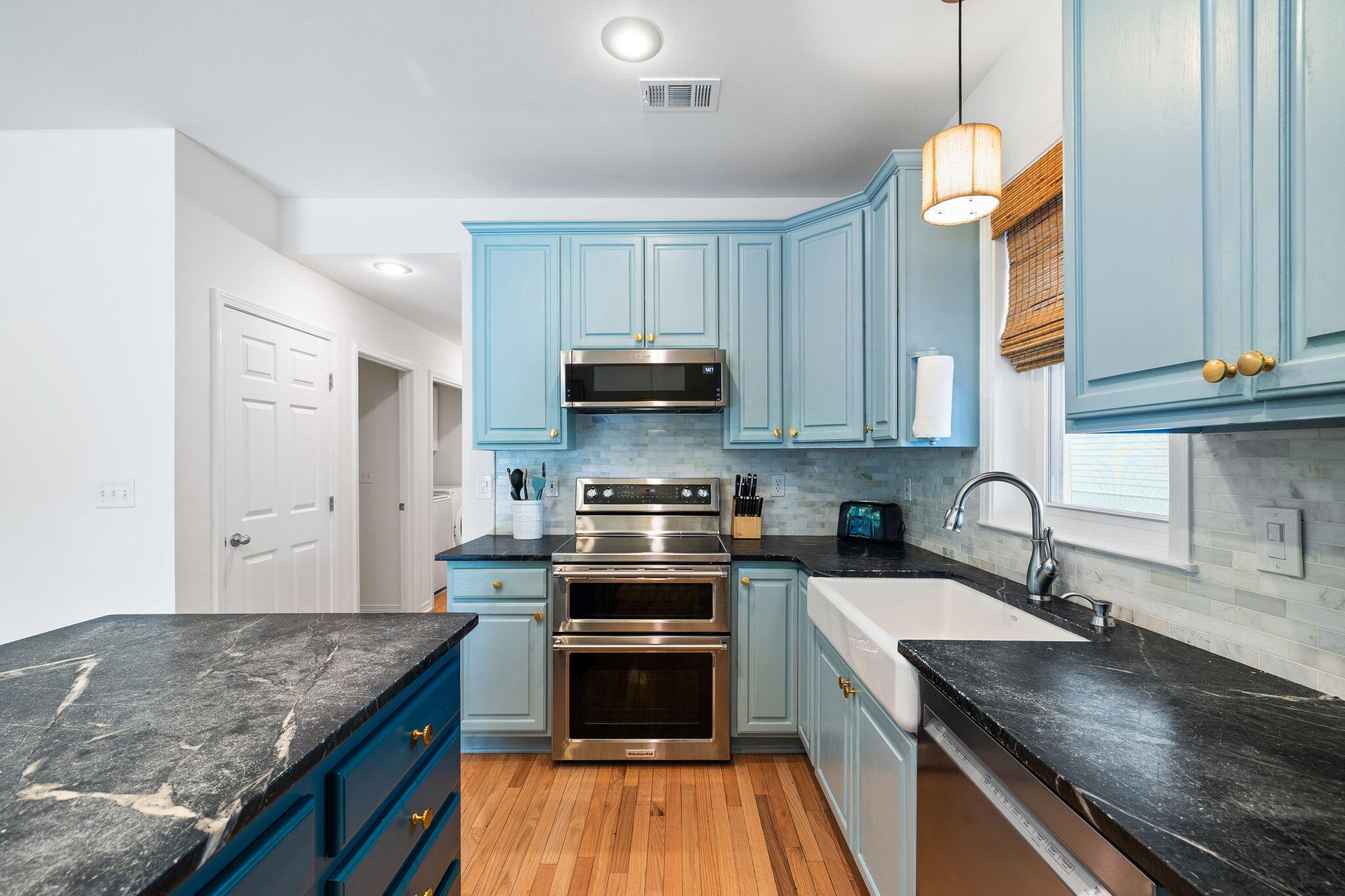 85 Dolphin Street Destin, FL 32541 - Photo 25 of 63 a kitchen with granite countertop a sink a counter top space stove and cabinets
