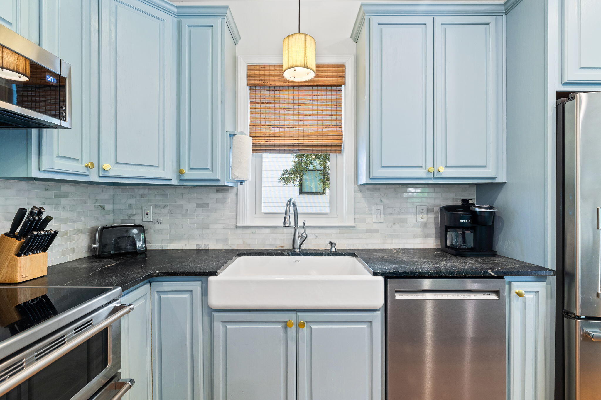85 Dolphin Street Destin, FL 32541 - Photo 26 of 63 a kitchen with stainless steel appliances granite countertop a sink stove and cabinets