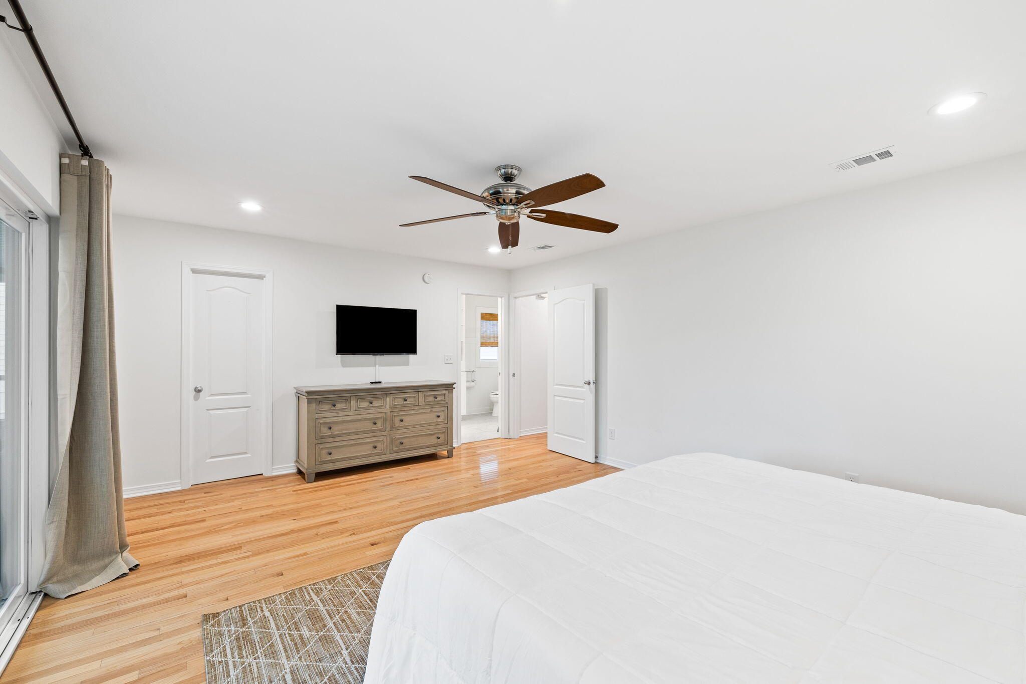 85 Dolphin Street Destin, FL 32541 - Photo 36 of 63 a bedroom with a bed and a flat screen tv