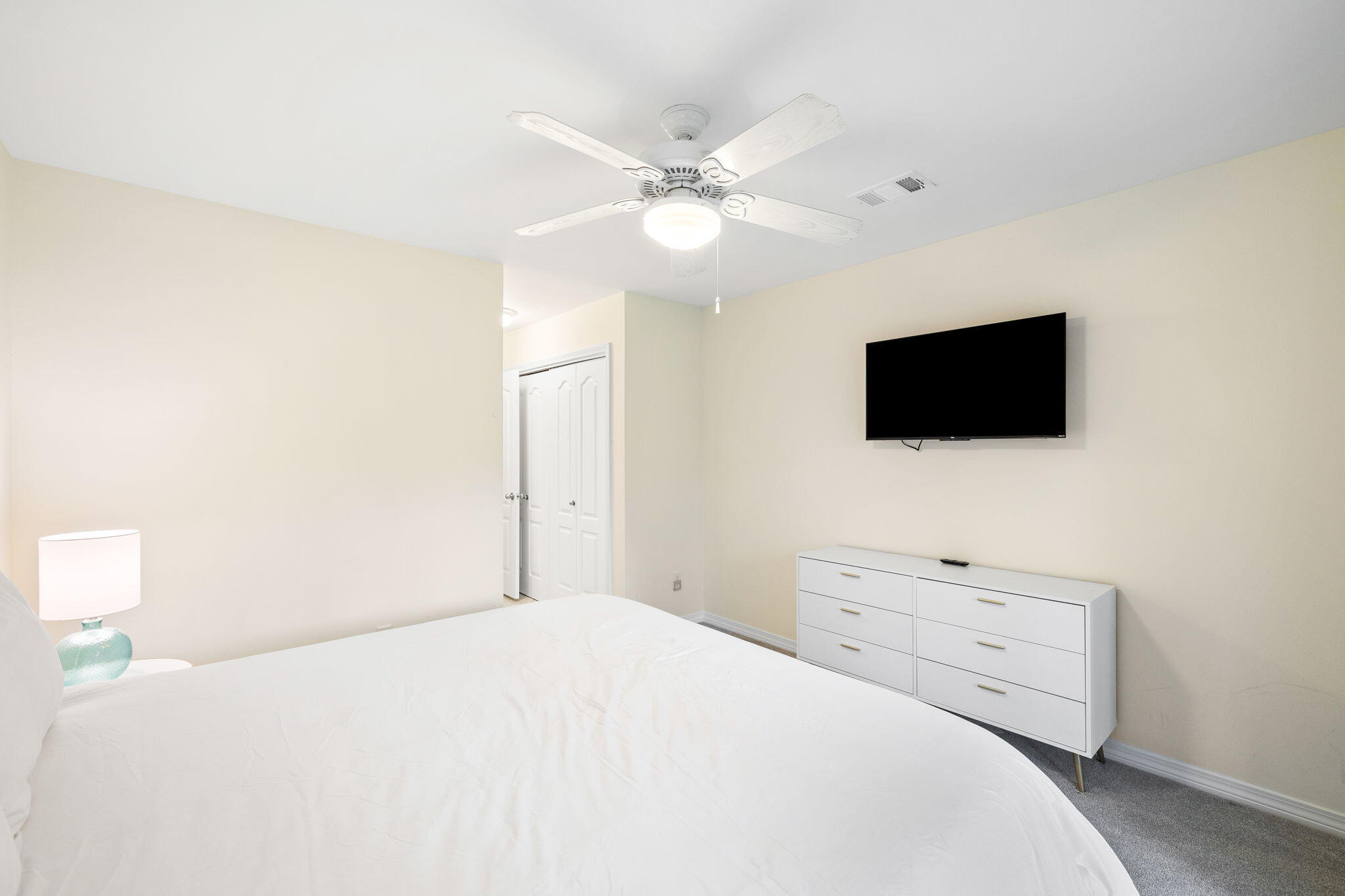 85 Dolphin Street Destin, FL 32541 - Photo 49 of 63 a bedroom with a bed and a flat screen tv