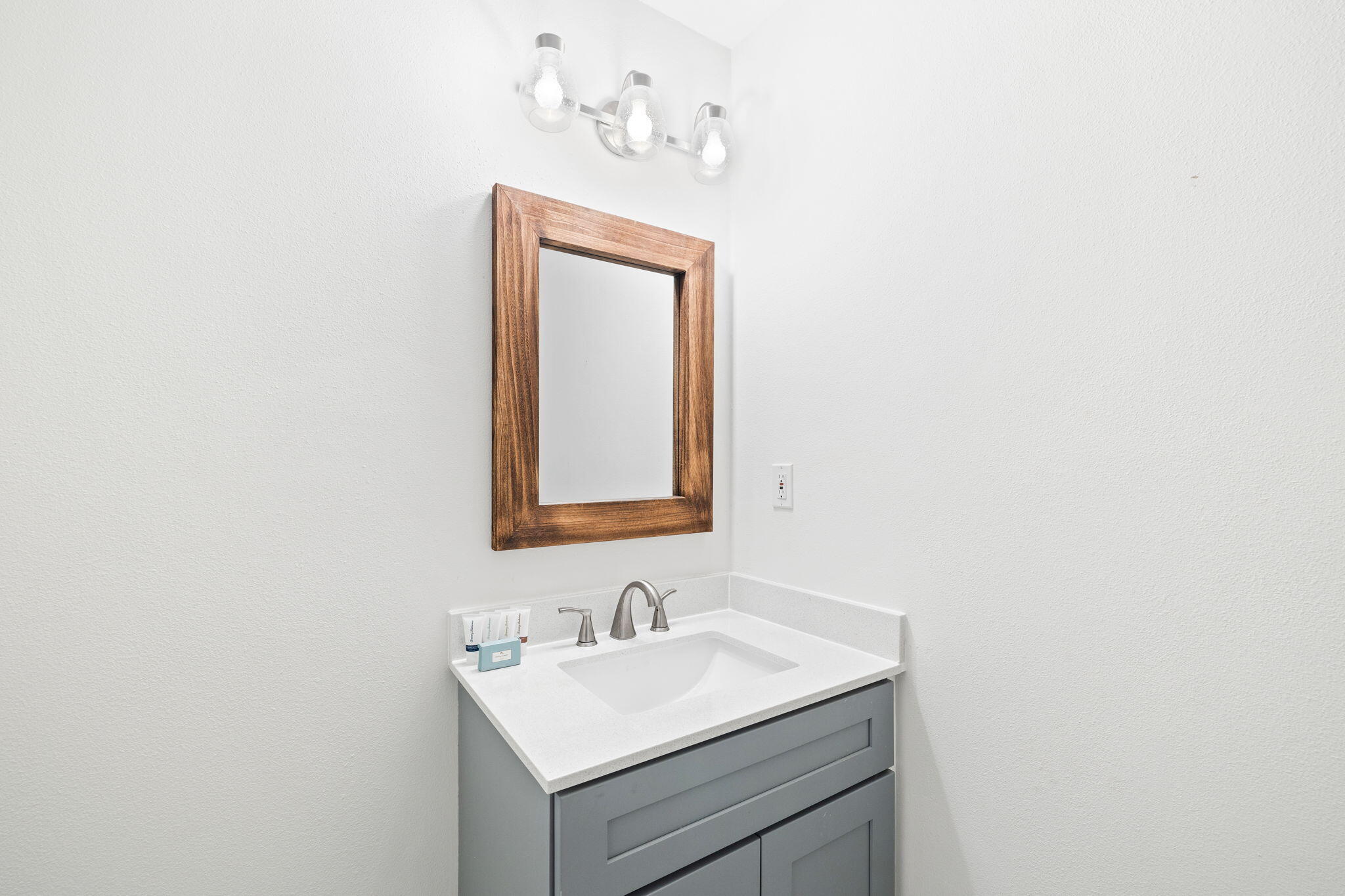 85 Dolphin Street Destin, FL 32541 - Photo 50 of 63 a bathroom with a sink vanity and a mirror