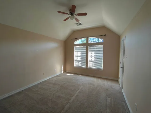 a view of room with a ceiling fan and window