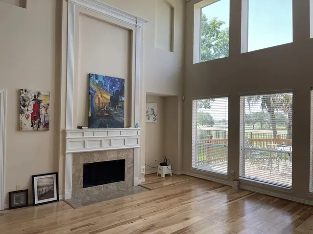 a view of a livingroom with a fireplace and a window