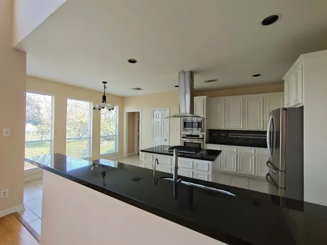 a kitchen with stainless steel appliances a sink stove and refrigerator