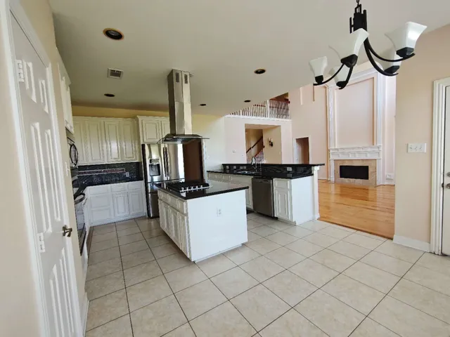 a kitchen with a refrigerator and microwave