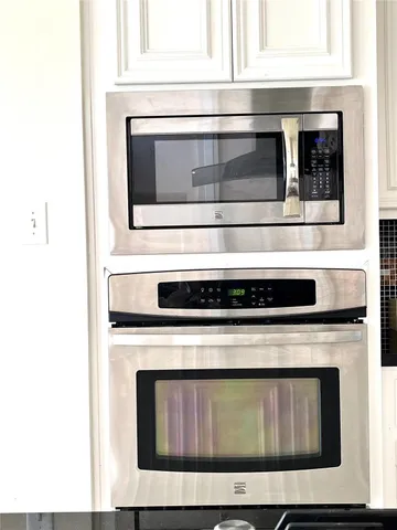 a stove top oven sitting inside of a kitchen
