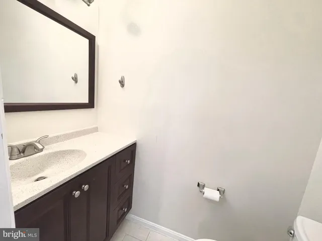 a bathroom with a sink vanity and a mirror