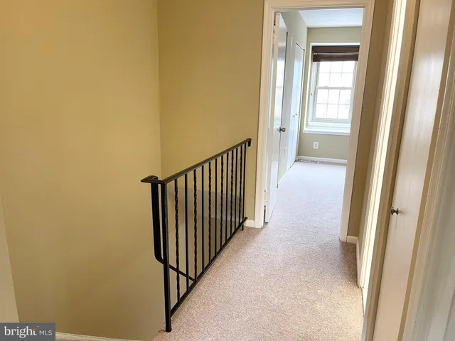 a view of a hallway with a door