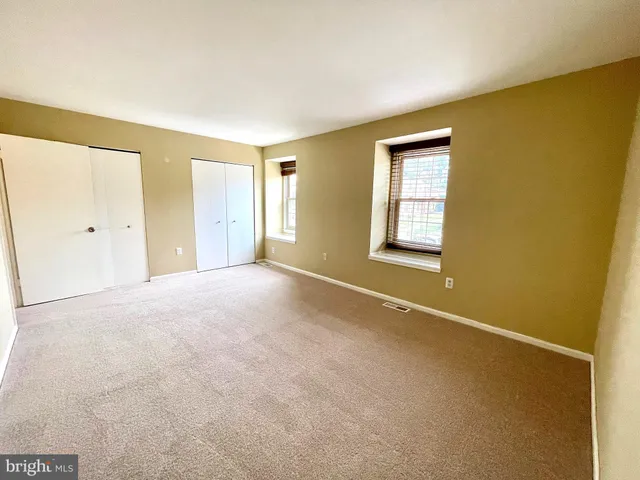 a view of an empty room with windows