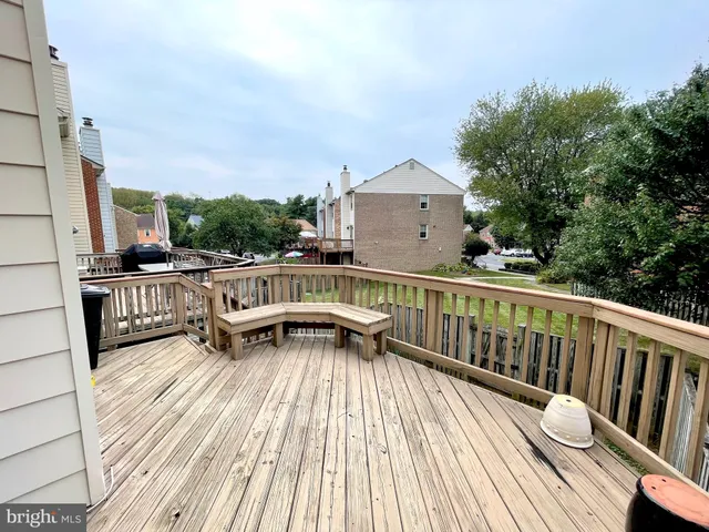 a view of balcony with wooden floor and outdoor seating