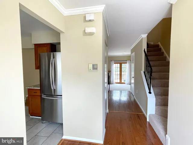 a view of a hallway view with wooden floor and staircase