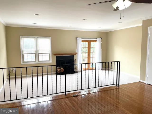 a view of a room with wooden floor and windows