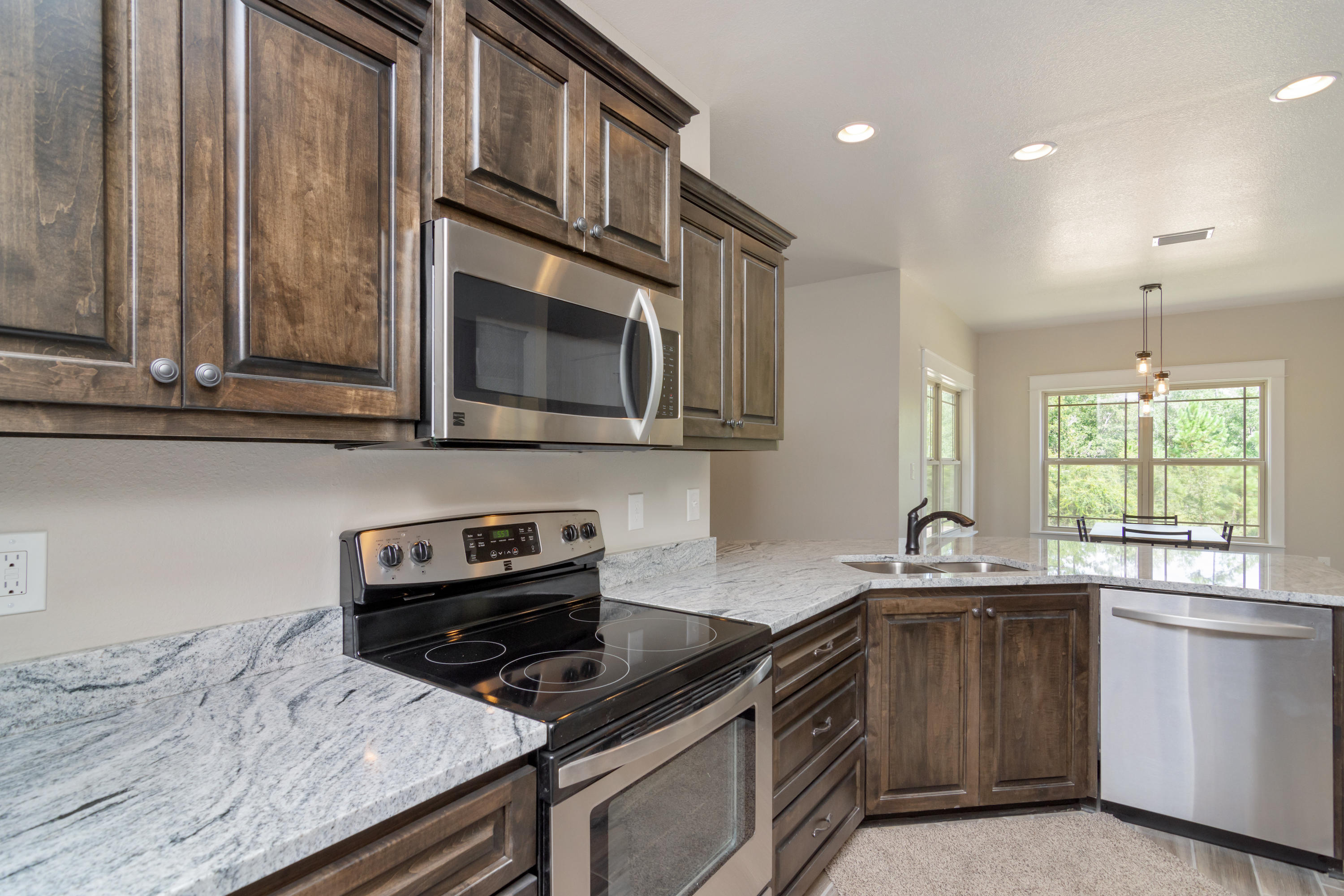 4070 Happy Trails Road Crestview, FL 32539 - Photo 14 of 34 a kitchen with stainless steel appliances granite countertop a sink stove and microwave