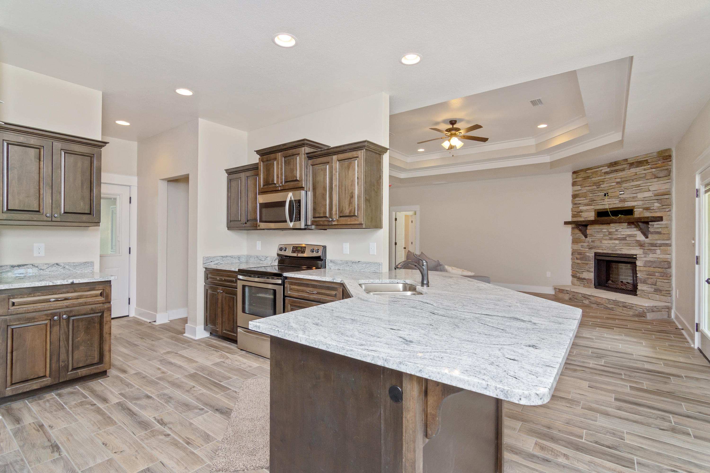 4070 Happy Trails Road Crestview, FL 32539 - Photo 8 of 34 a kitchen with stainless steel appliances granite countertop a kitchen island hardwood floor sink and stove
