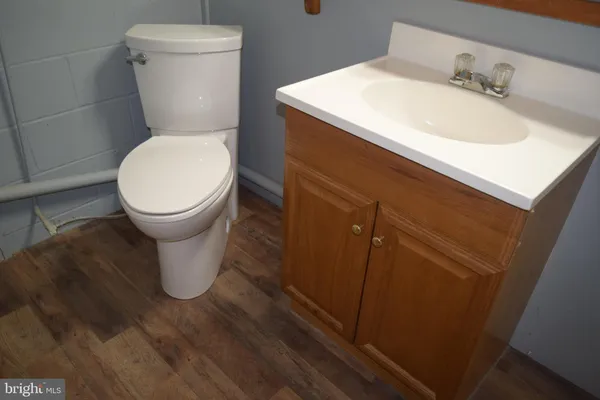 a white toilet sitting next to a bathroom sink