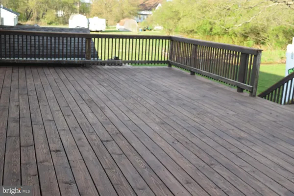 a view of deck with wooden floor and fence