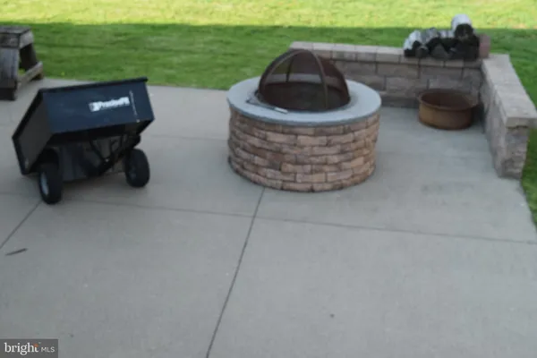 a couple of chairs sitting in patio with a yard