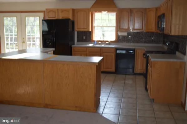 a kitchen with a refrigerator and a sink