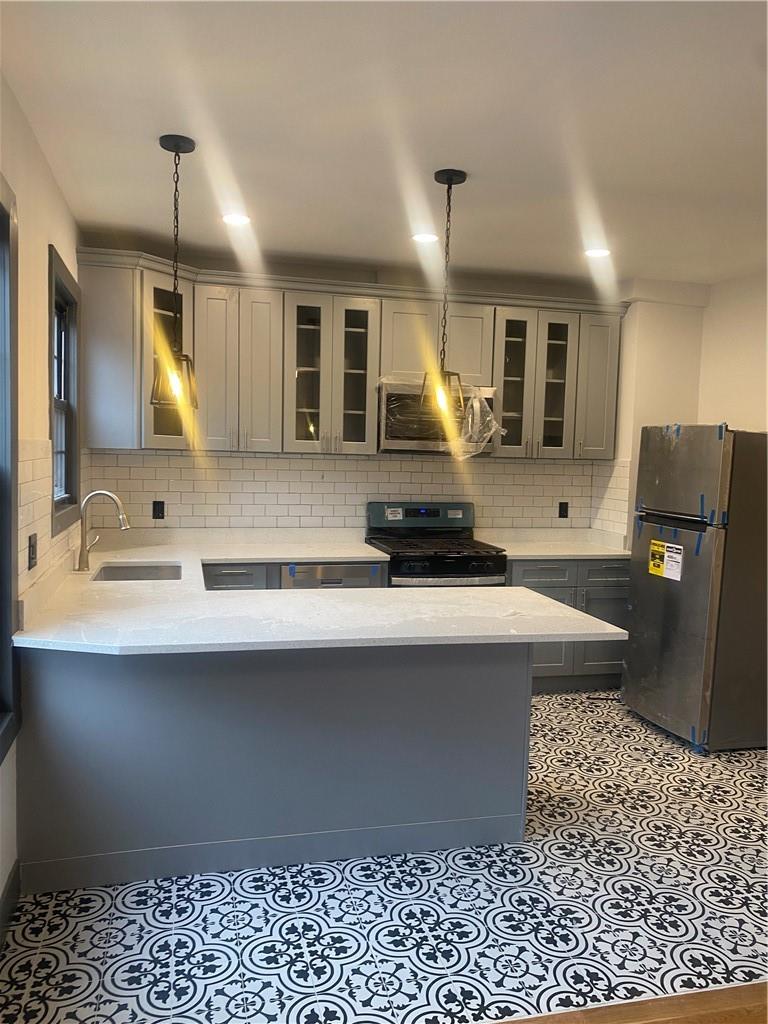 a kitchen with a sink appliances and cabinets