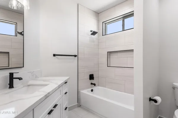 a bathroom with a tub sink and mirror