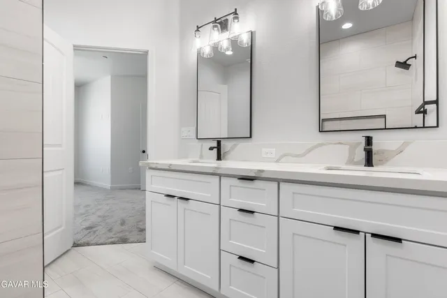 a bathroom with double sink and a mirror