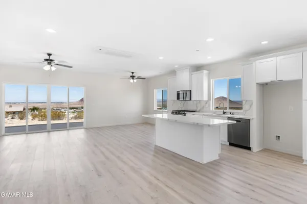 a kitchen with stainless steel appliances a sink and a refrigerator