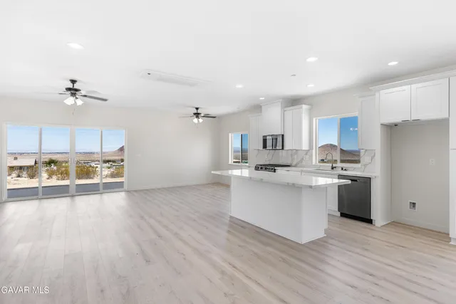 a kitchen with stainless steel appliances a sink and a refrigerator