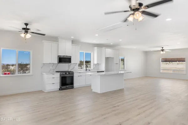 a view of kitchen with sink microwave and stove