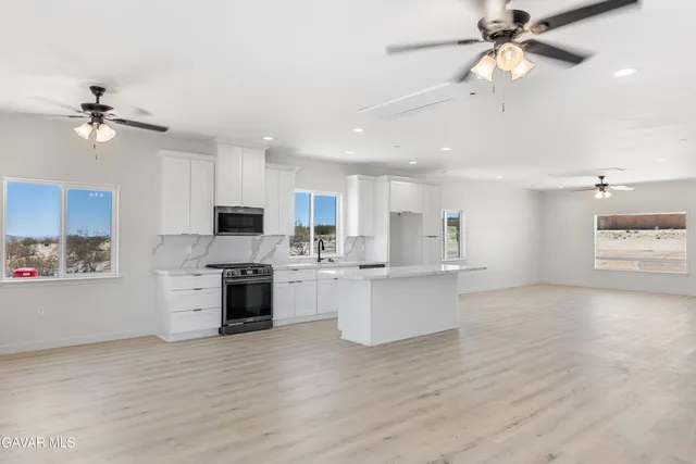 a view of kitchen with sink microwave and stove
