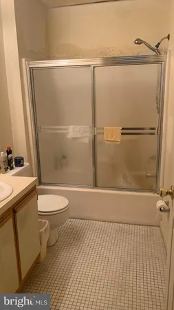 a bathroom with a toilet a sink and shower