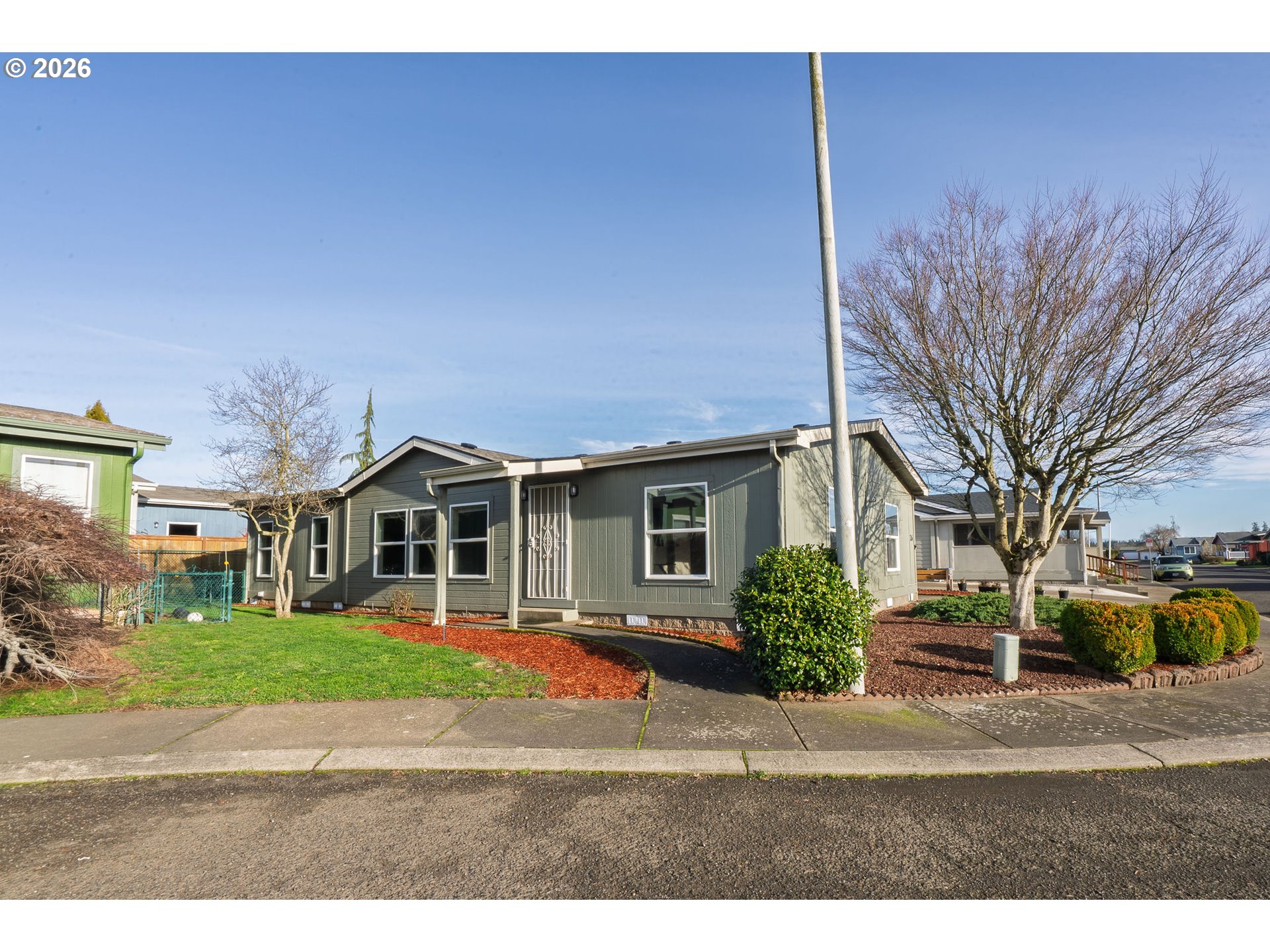 11105 Main Street Northeast Donald, OR 97020 - Photo 2 of 22 a front view of a house with a garden and trees