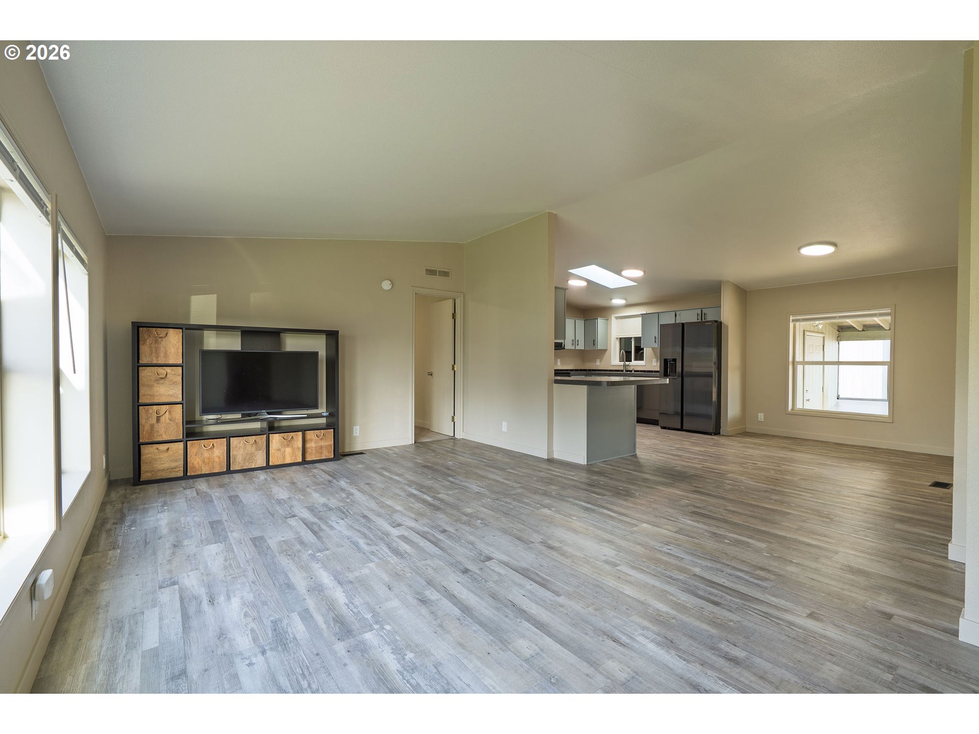 11105 Main Street Northeast Donald, OR 97020 - Photo 10 of 22 a view of empty room with wooden floor and kitchen