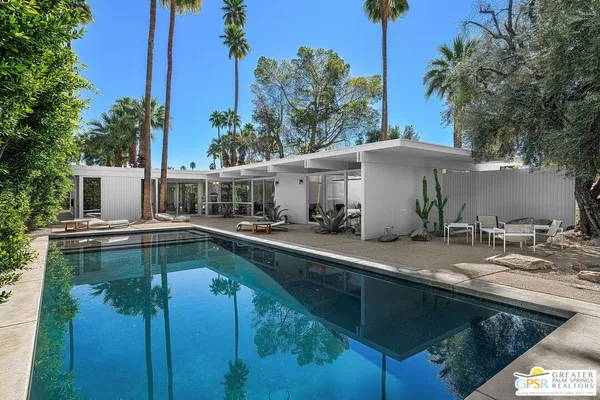 a view of a backyard with a tub and chairs