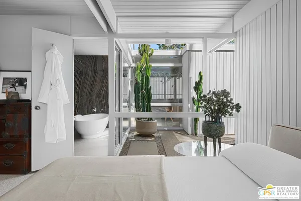 a bedroom with a bed and a couch