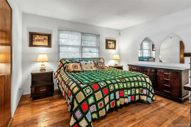 a bedroom with a bed window and a dresser