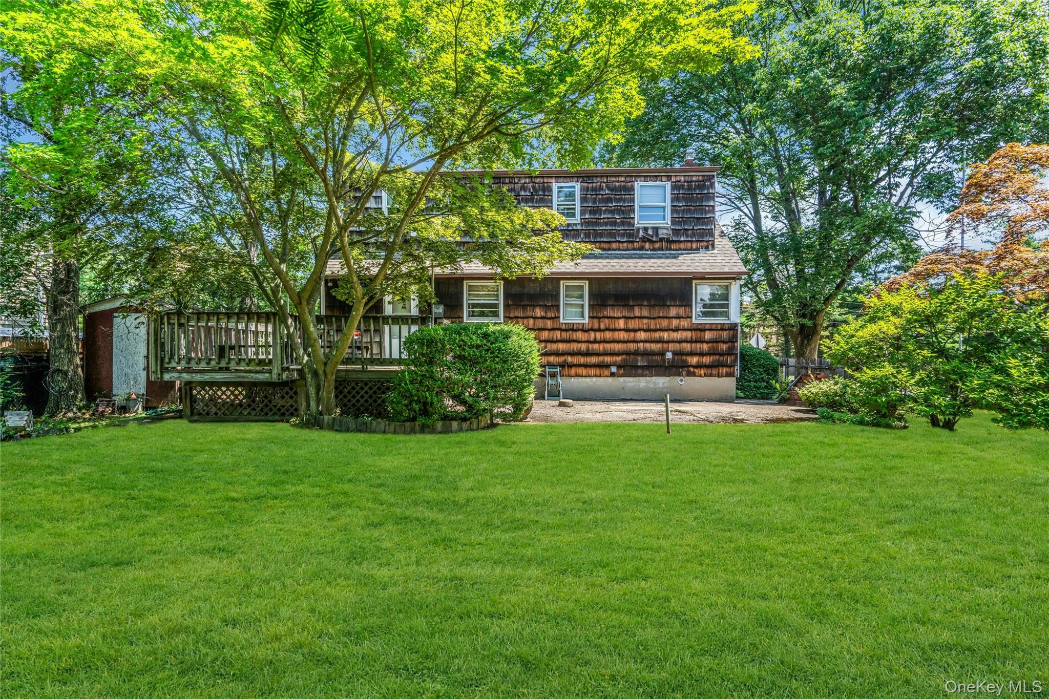 42 Summit Street Plainview, NY 11803 - Photo 20 of 22 a front view of a house with garden