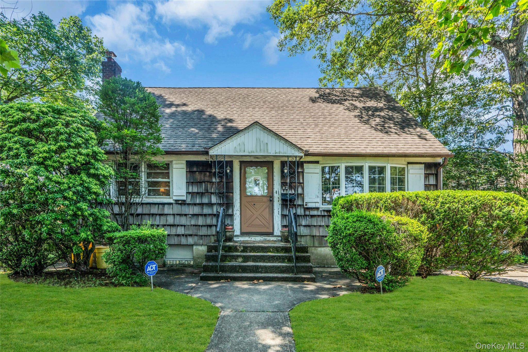 42 Summit Street Plainview, NY 11803 - Photo 2 of 22 a front view of a house with a yard