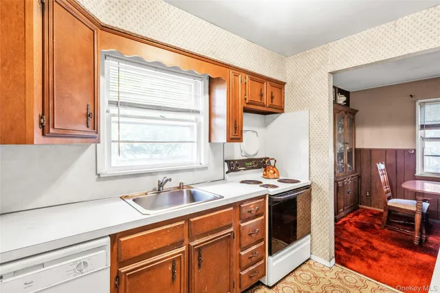 a kitchen that has a sink and a stove in it