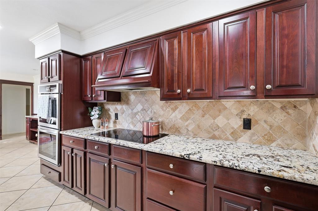 6724 Kirkwood Road Fort Worth, TX 76116 - Photo 19 of 40 a kitchen with stainless steel appliances granite countertop wooden cabinets a sink and dishwasher