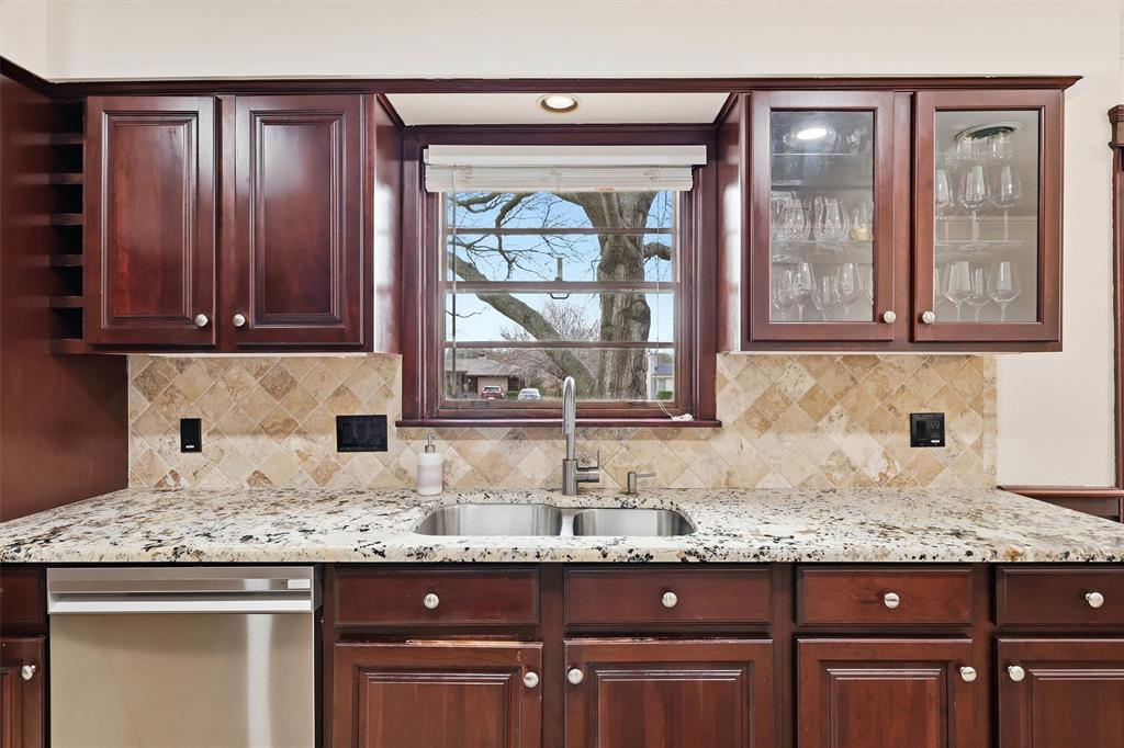 6724 Kirkwood Road Fort Worth, TX 76116 - Photo 23 of 40 a kitchen with granite countertop a sink and cabinets