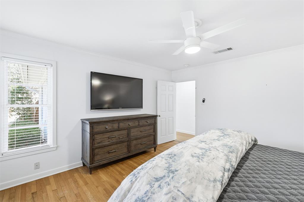 6724 Kirkwood Road Fort Worth, TX 76116 - Photo 25 of 40 a bedroom with a bed and a flat screen tv
