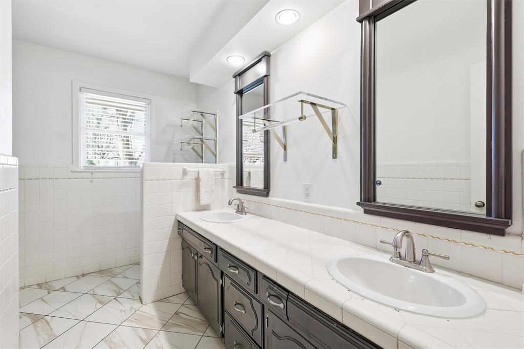 6724 Kirkwood Road Fort Worth, TX 76116 - Photo 26 of 40 a bathroom with a sink and a mirror