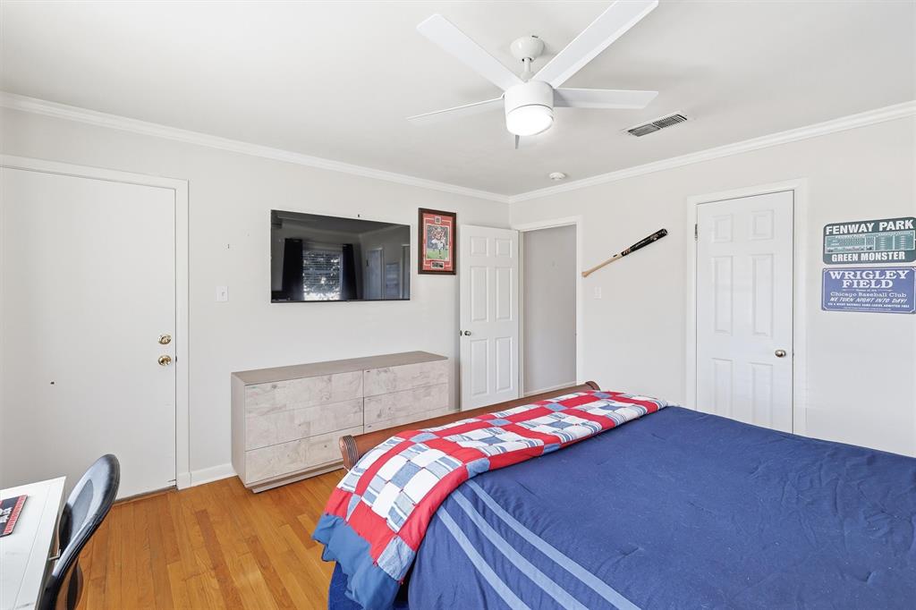 6724 Kirkwood Road Fort Worth, TX 76116 - Photo 28 of 40 a bedroom with a bed and a flat screen tv