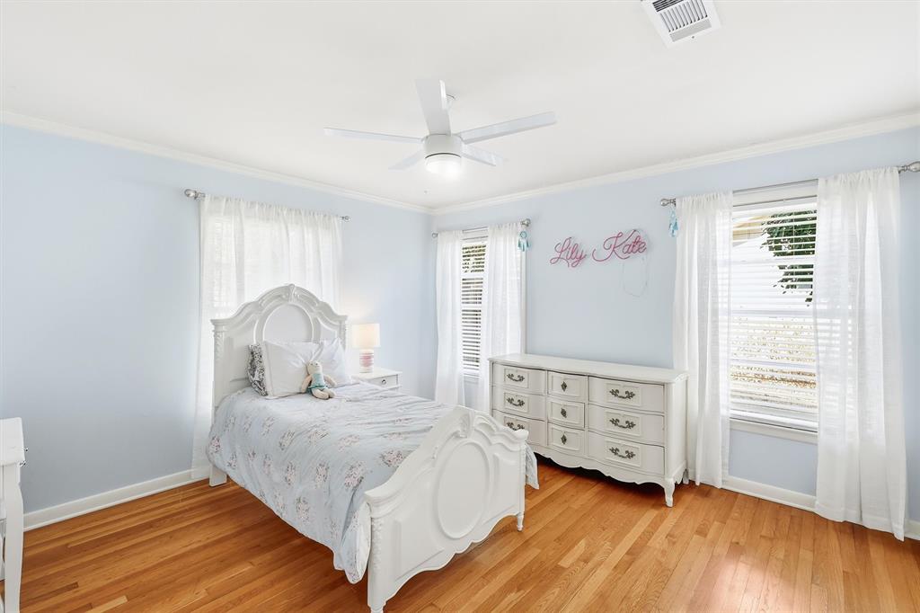 6724 Kirkwood Road Fort Worth, TX 76116 - Photo 30 of 40 a bedroom with a bed and wooden floor